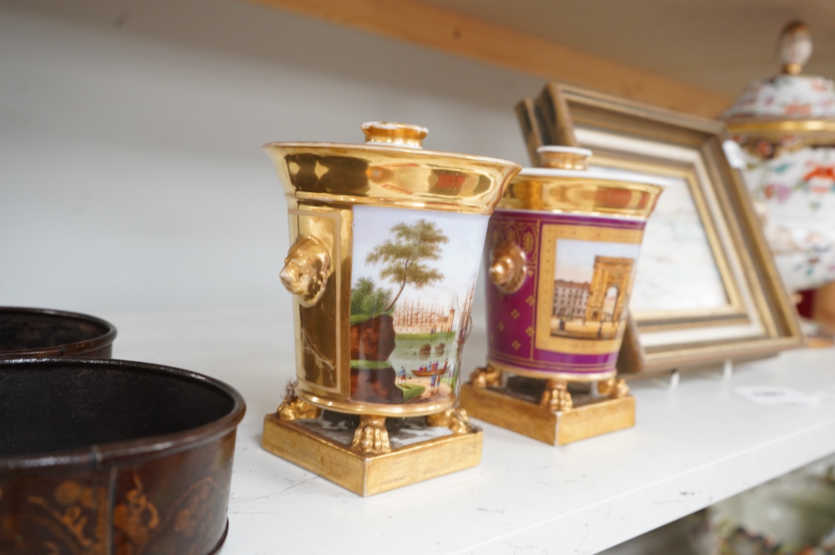 Two early 19th century Paris porcelain pastel burners and covers, decorated with continental landscapes, 15cm high
